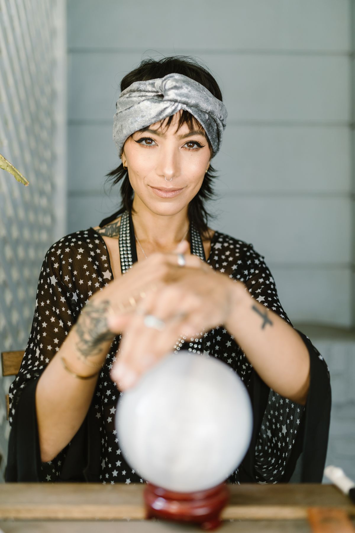Adult woman with a headscarf gazing over a crystal ball for halloween costume ideas for adults