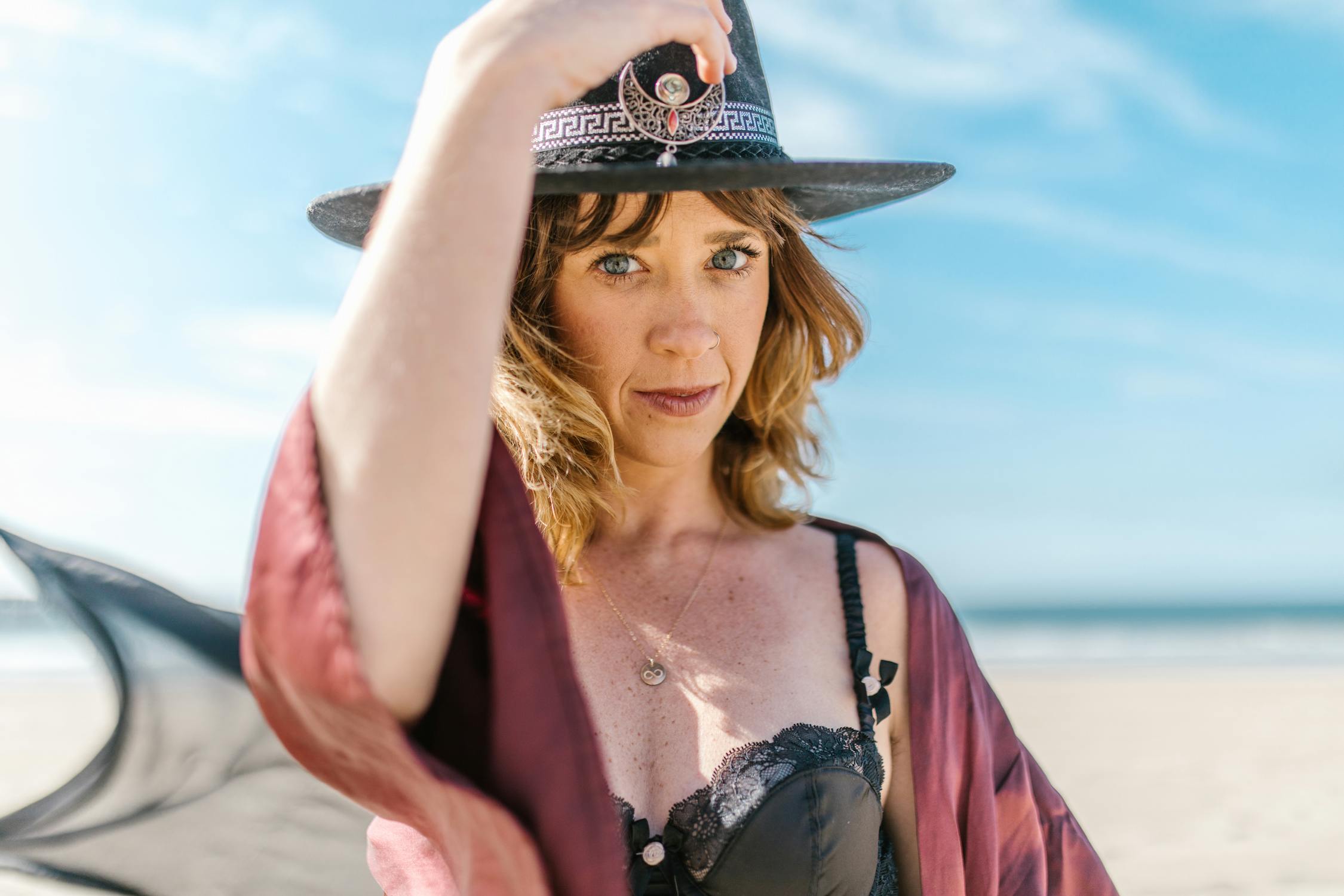 Woman in Black and White Fedora Hat and Purple Robe
