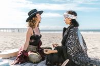 2 Women Sitting on Beach