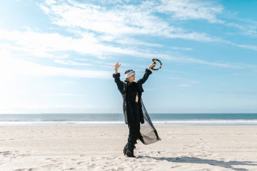 Man in Black Jacket and Pants Standing on Beach Shore