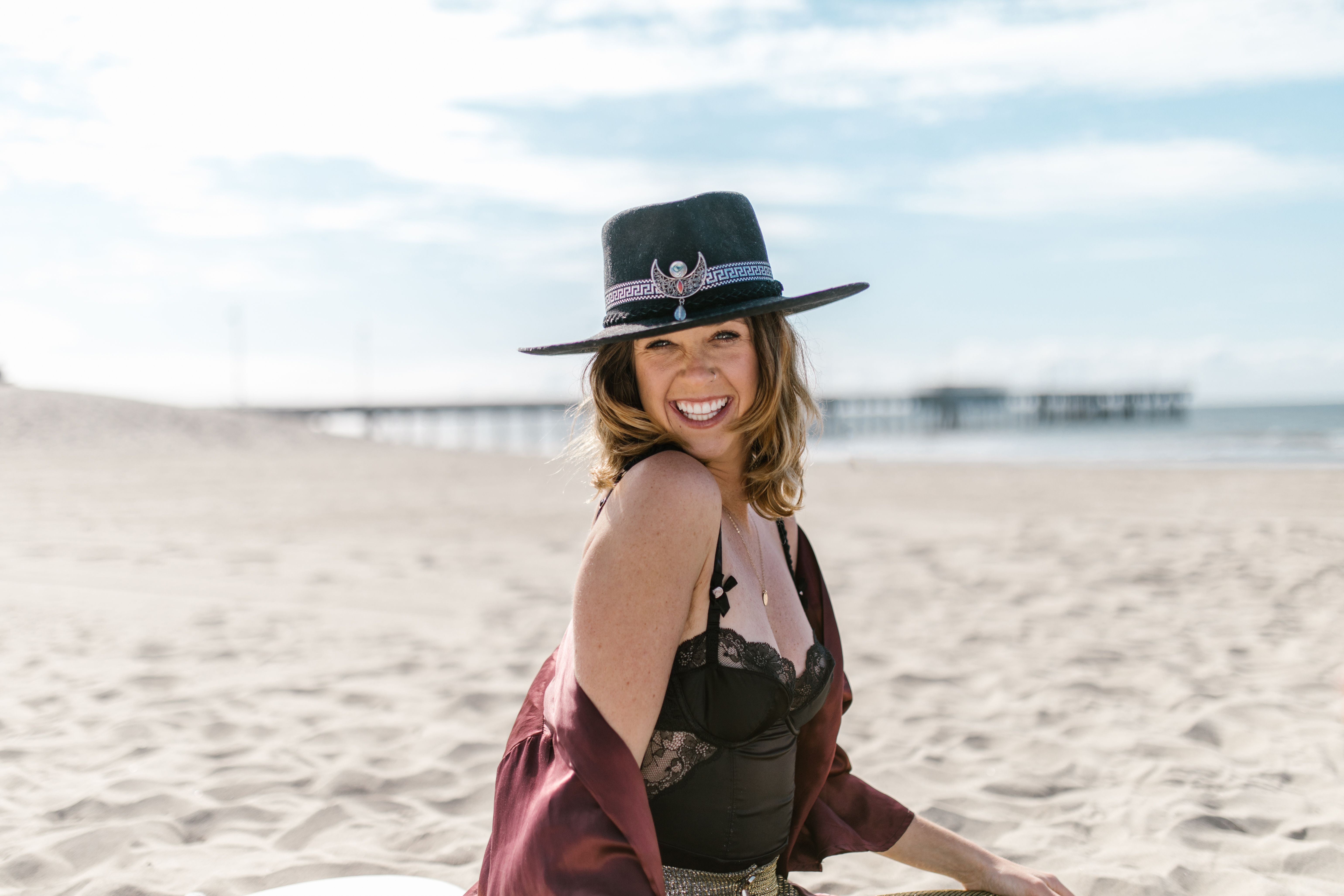 Woman in Black Sun Hat and Red Dress Sitting on White Sand · Free Stock ...