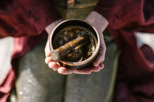Person Holding a Singing Bowl