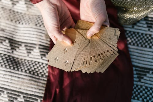 Free Person Holding Brown Playing Cards Stock Photo