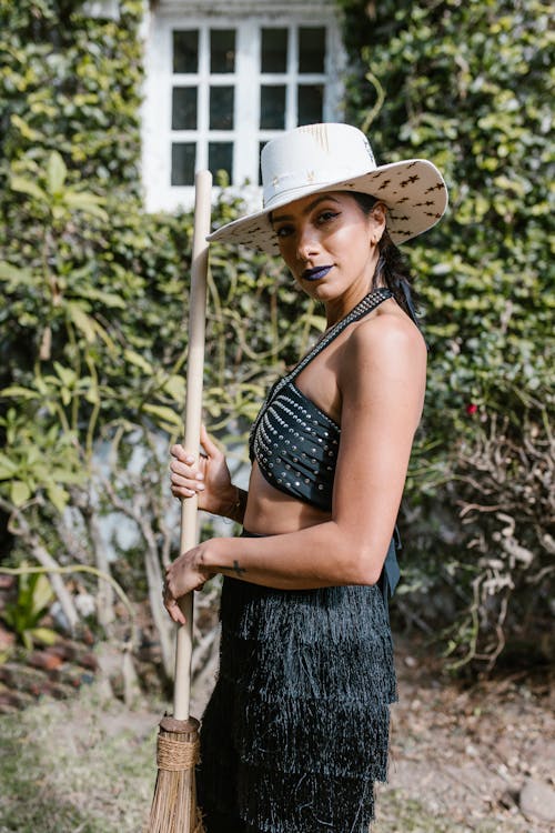 A Woman in Black Brassier Wearing White Hat