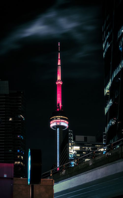 Free Stunning nighttime shot of Toronto's CN Tower illuminated against the skyline. Stock Photo