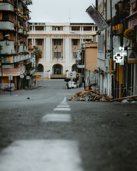 Quiet urban street with historic architecture, showcasing an empty and decayed cityscape.