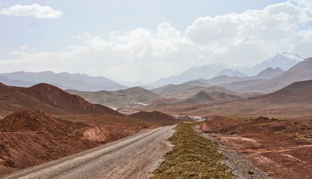 A remote desert road winds through Telouet's dramatic landscape in Morocco.
