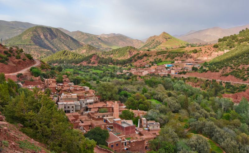 The Ourika valley with red earth villages and terraced fields below the Atlas