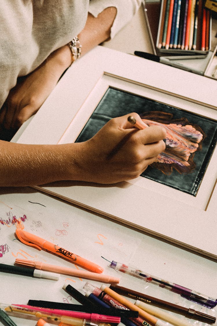 Woman Creating Picture With Pencil At Table