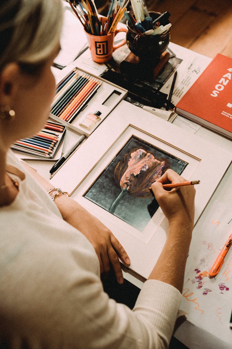 Woman Drawing Surrealistic Picture At Table