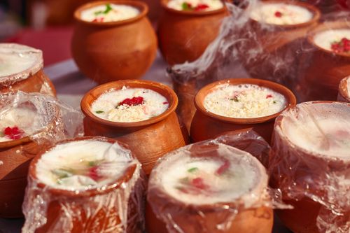 Free Steaming yogurt served in traditional clay pots with fresh toppings, a delightful treat. Stock Photo