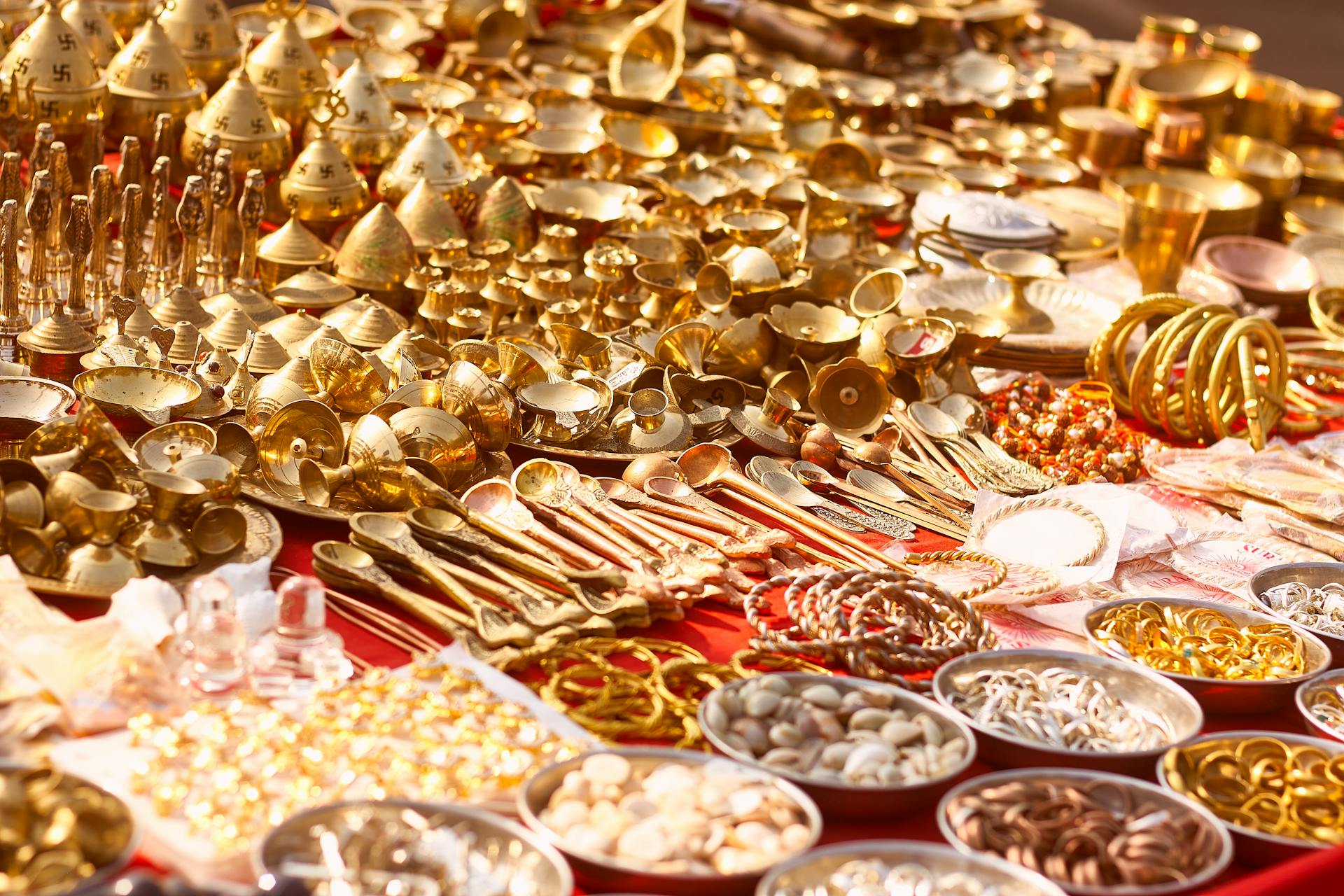 A vibrant display of golden traditional items at a market stall, showcasing luxury and abundance.