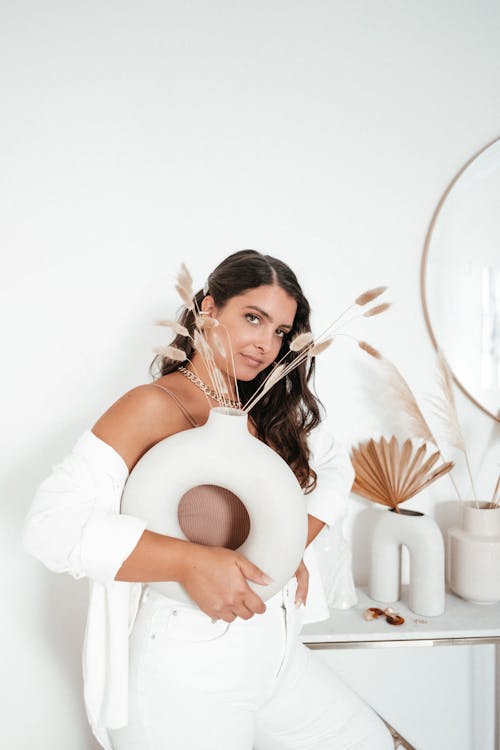 Free Woman in white clothes standing with vase Stock Photo