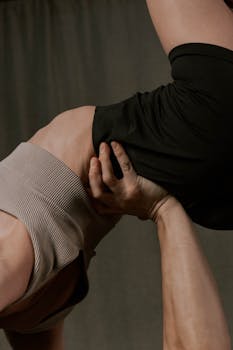 A close-up of a couple in a striking yoga pose showcasing strength, balance, and connection.