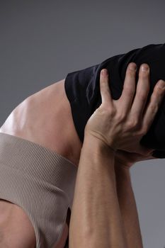 A detailed shot of a flexible acrobatic duo focusing on balance and strength.