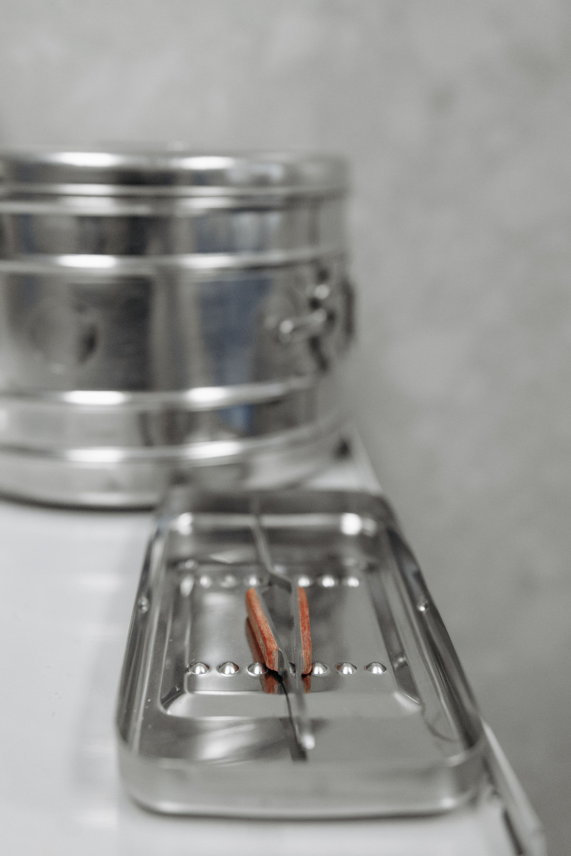 Close-up of sterile medical instruments on a tray in a clinic setting