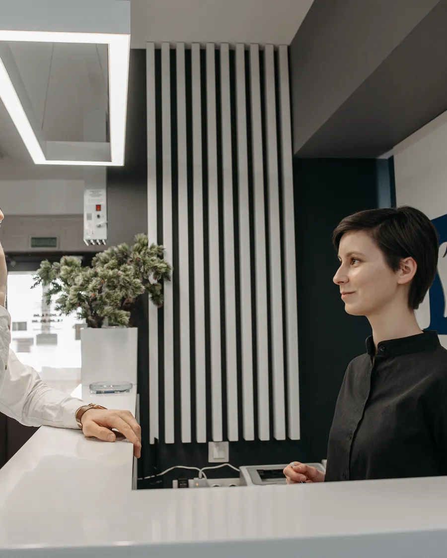 Dental front desk receptionist helping a patient