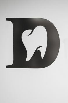 Simple black and white tooth design within letter D, ideal for dental branding. 6809665