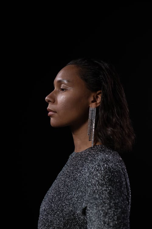 Side View of a Woman on Plain Black Background