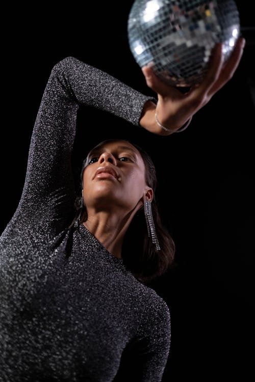 A Woman Holding a Disco Ball