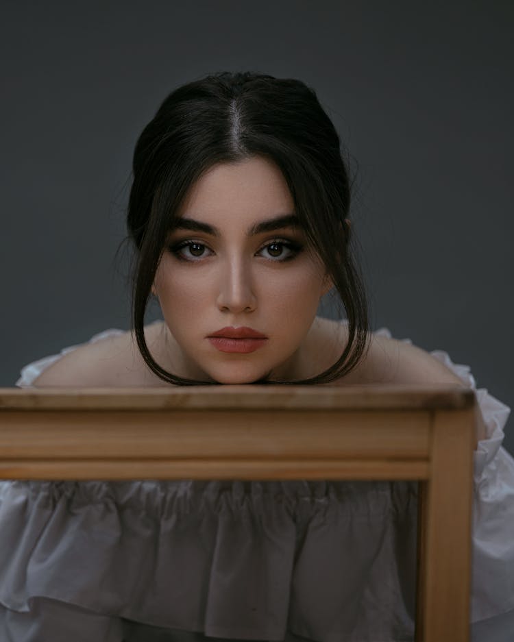 A Beautiful Woman With Her Head On A Desk