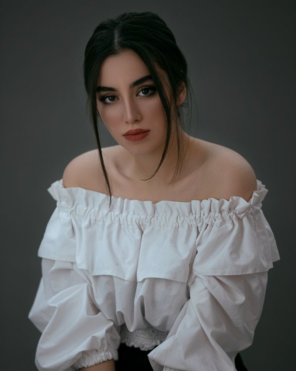 Woman in an off-shoulder top with a satin skirt
