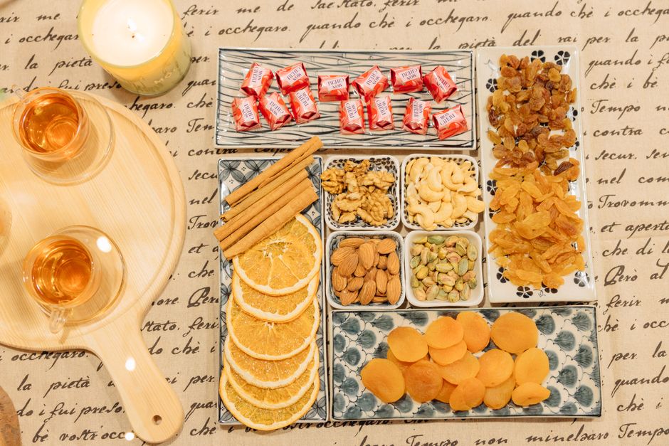 Top view of assorted snacks with tea and candlelight for a cozy setting. - Frequently Asked Questions