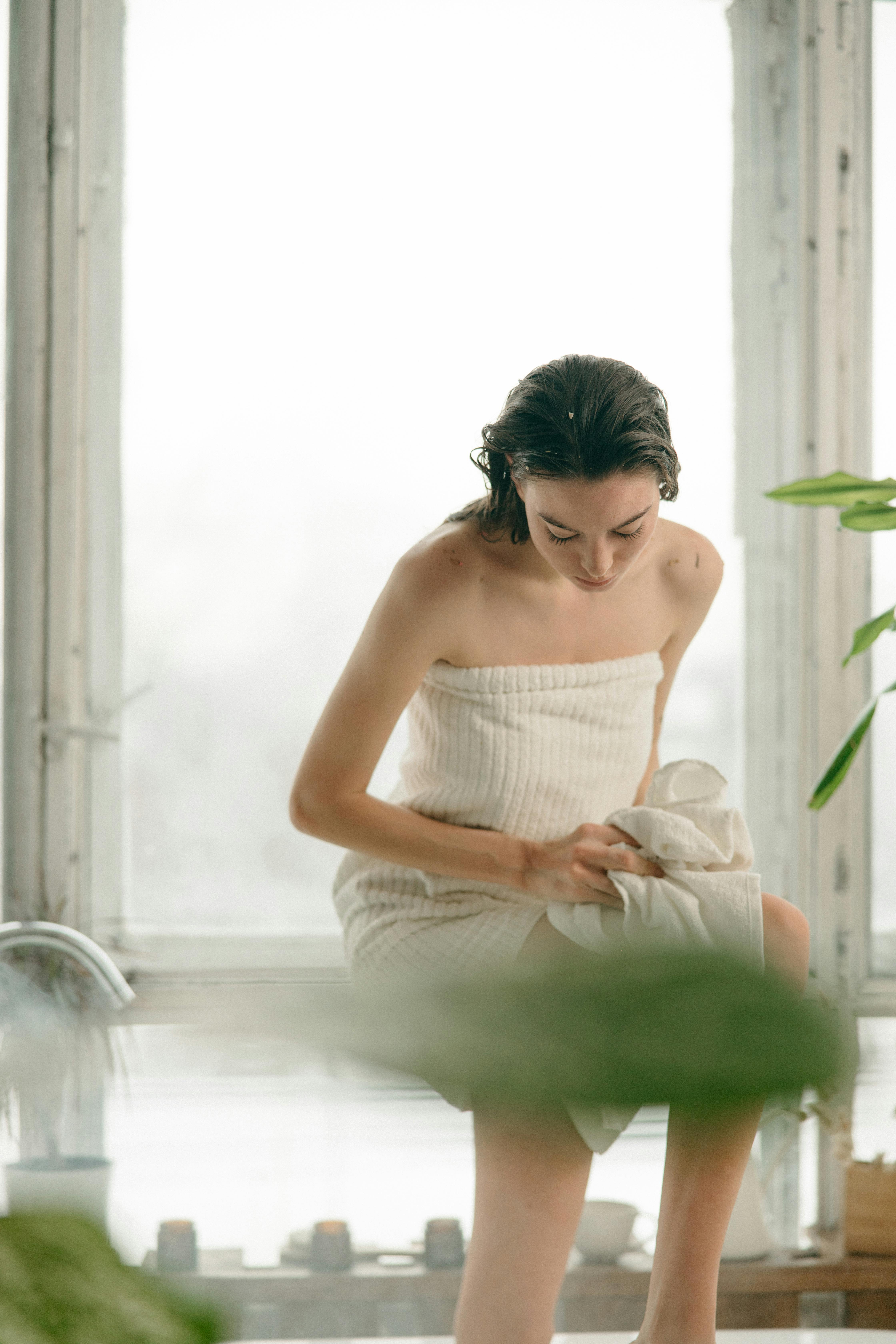 a woman sitting beside the glass window