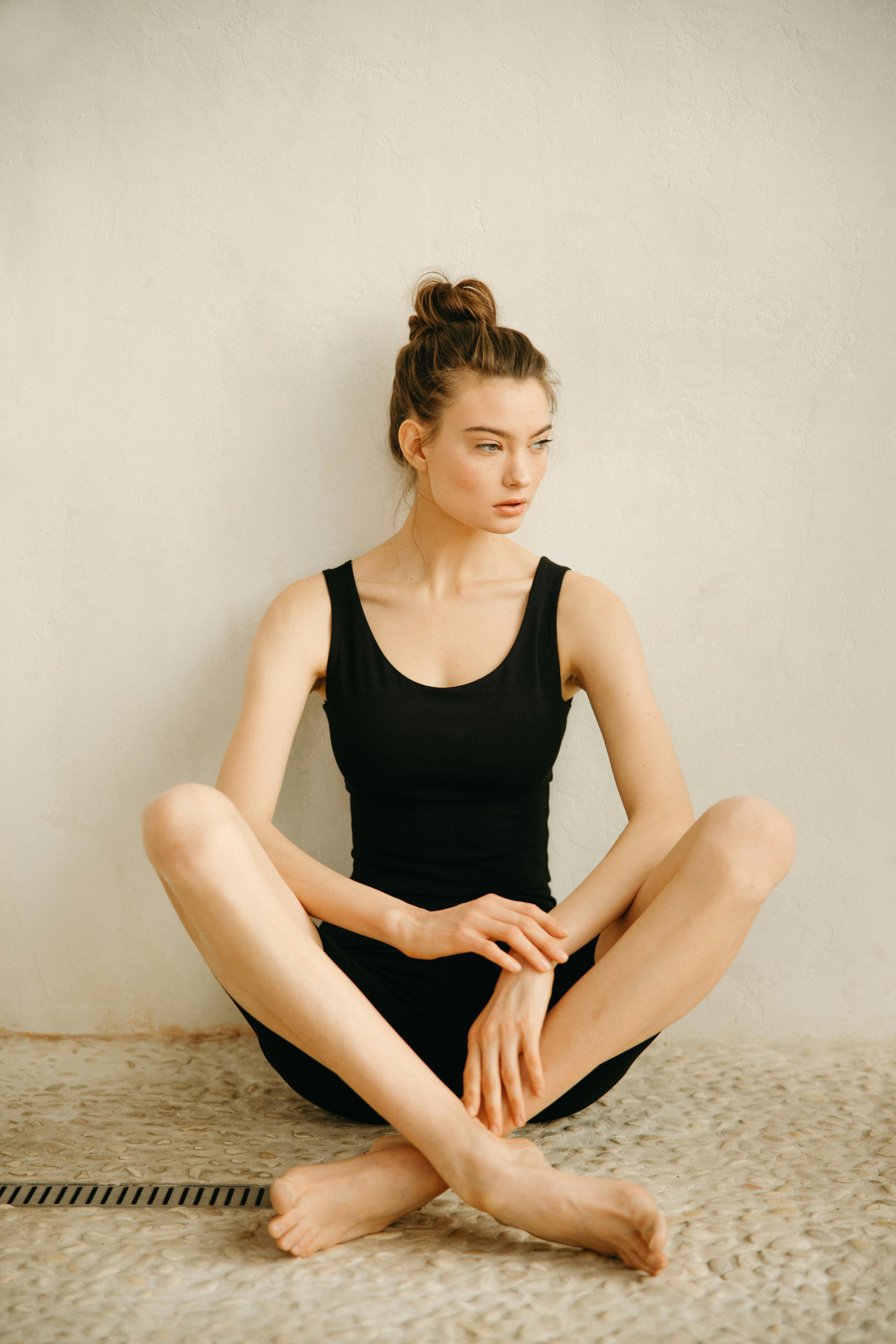 woman in black tank top sitting on floor