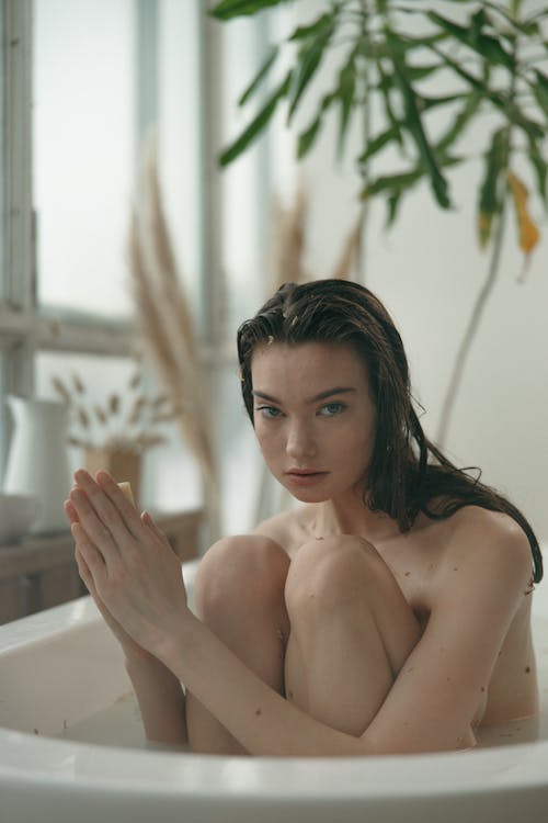 Close-Up Shot of a Topless Woman in the Bathtub