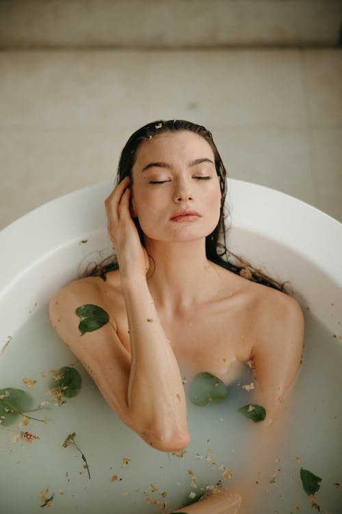 Free A Woman in White Bathtub With Water Stock Photo
