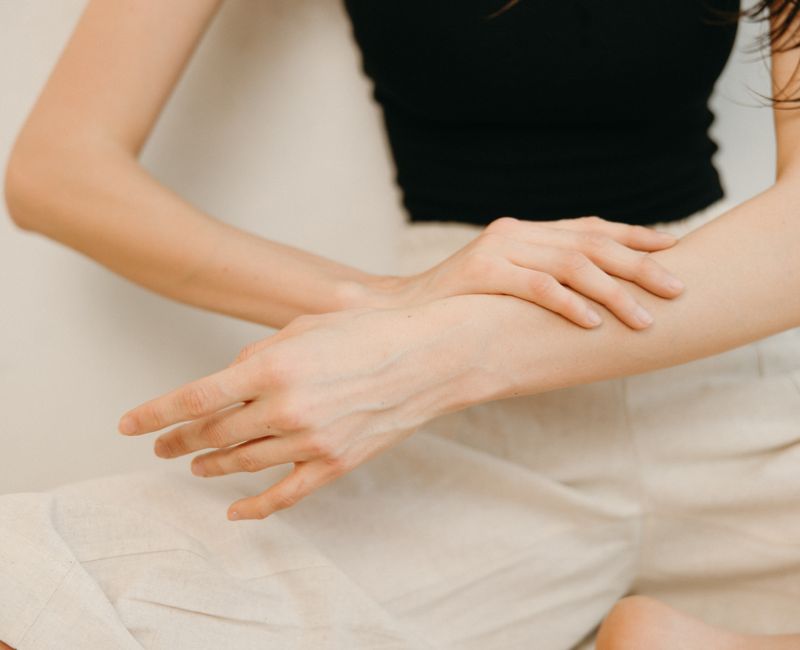 Close-up of a person applying a sleep patch on their arm