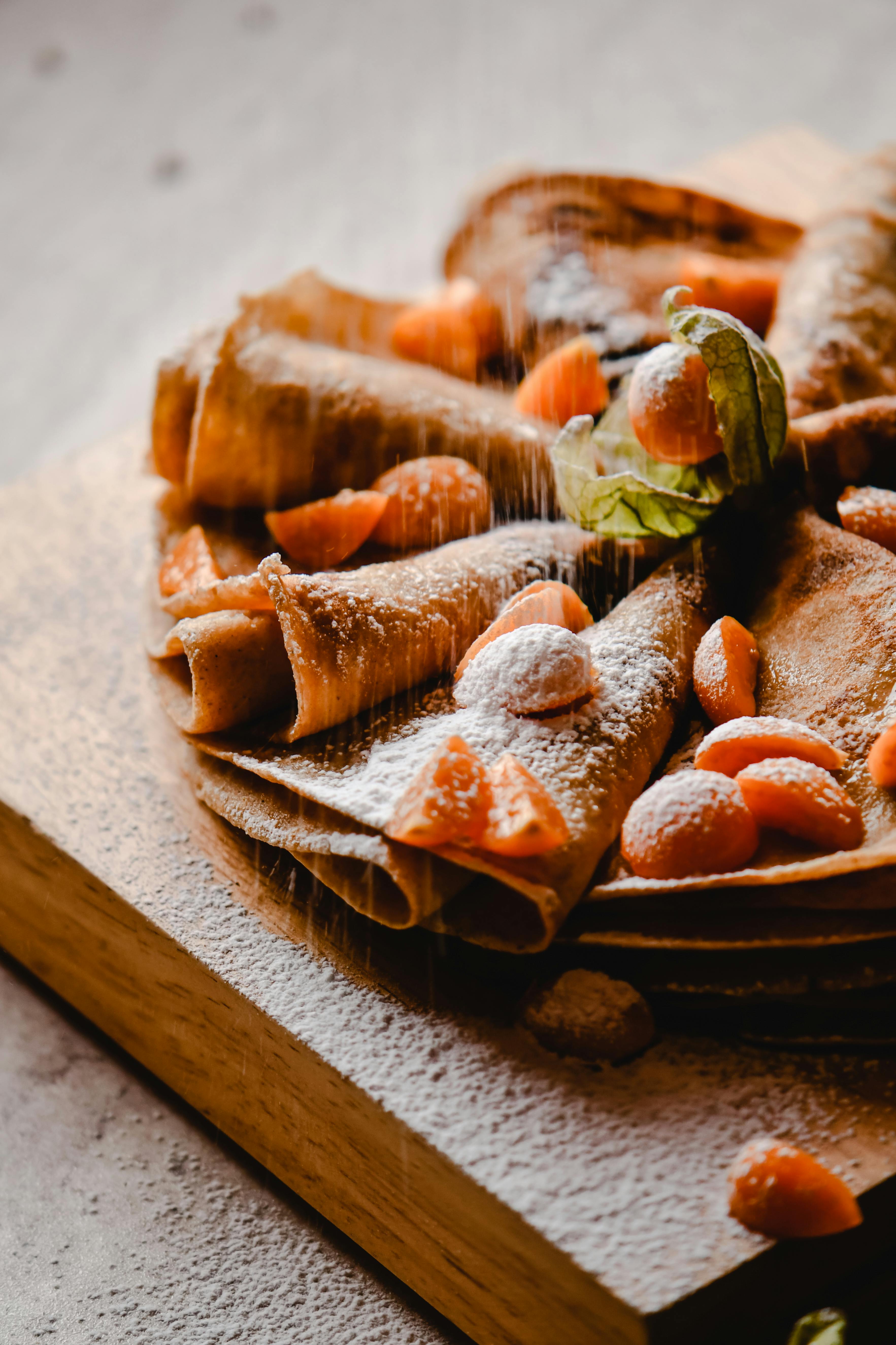 sliced fruits on top of crepe