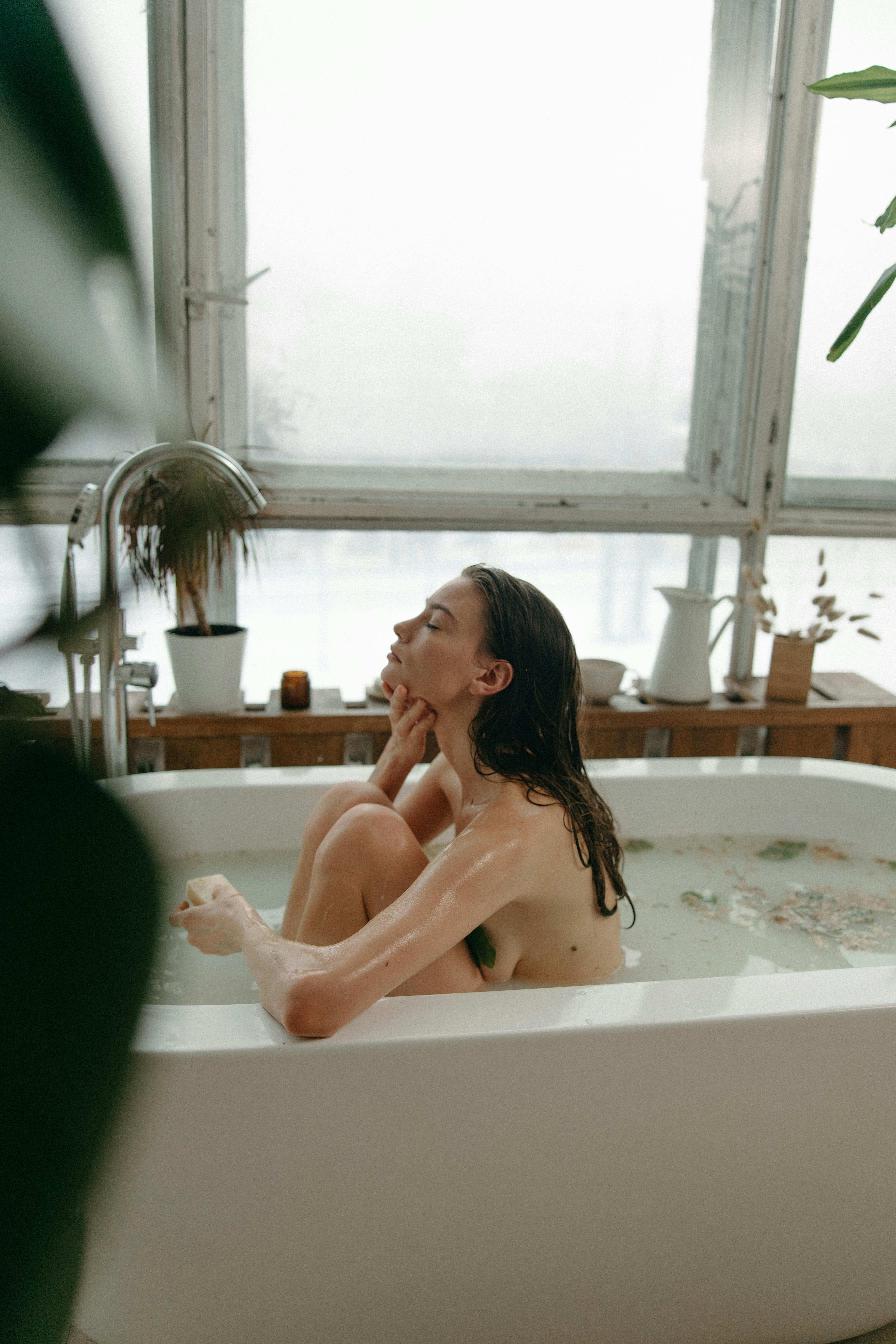 woman taking a bath in the bathtub