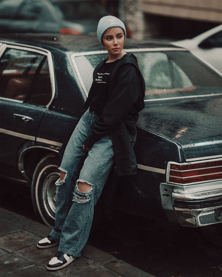 Stylish Woman Leaning On A Car