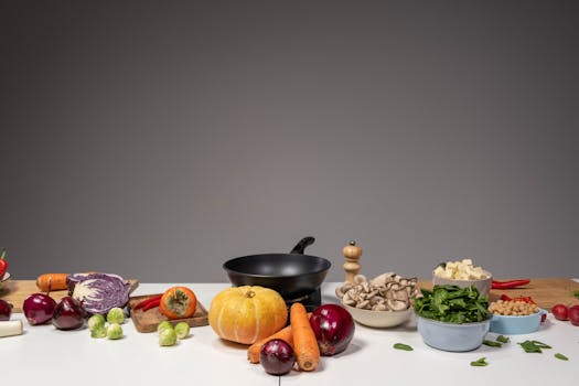 Studio composition of fresh vegetables and a frying pan, ideal for healthy cooking and recipe preparation.