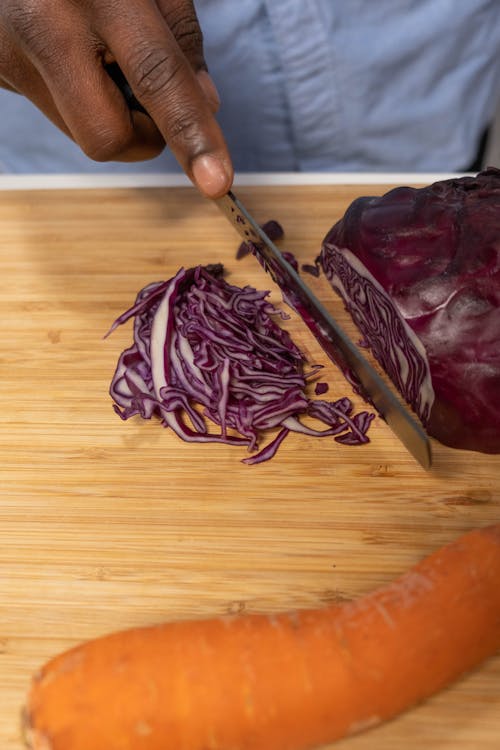 Free Close Up Photo of a Person Slicing Vegetable Stock Photo