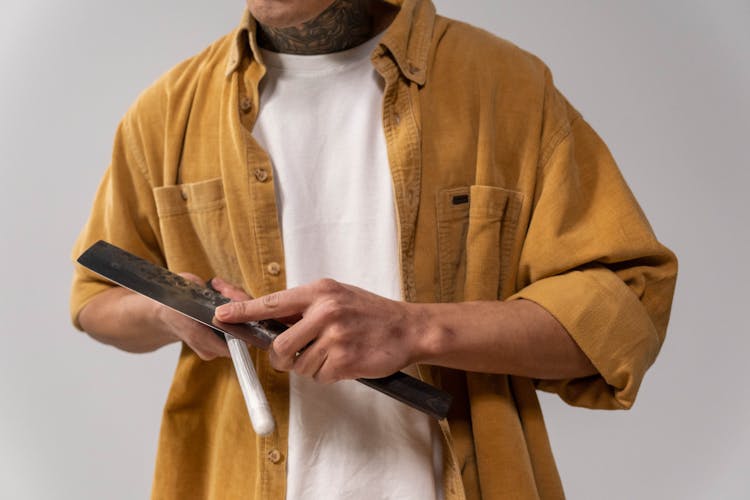 Man Sharpening A Knife