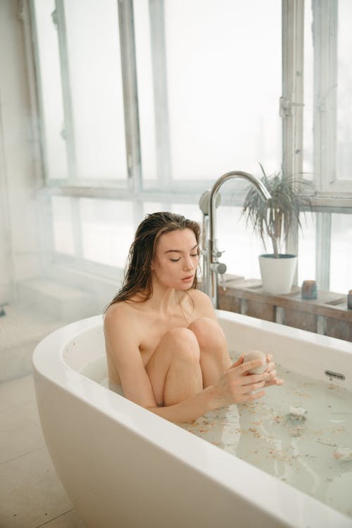 Free Naked Woman Sitting on a Bathtub Stock Photo