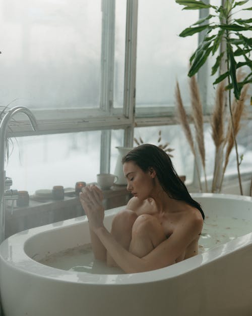 Free Woman Sitting in the Bathtub Stock Photo