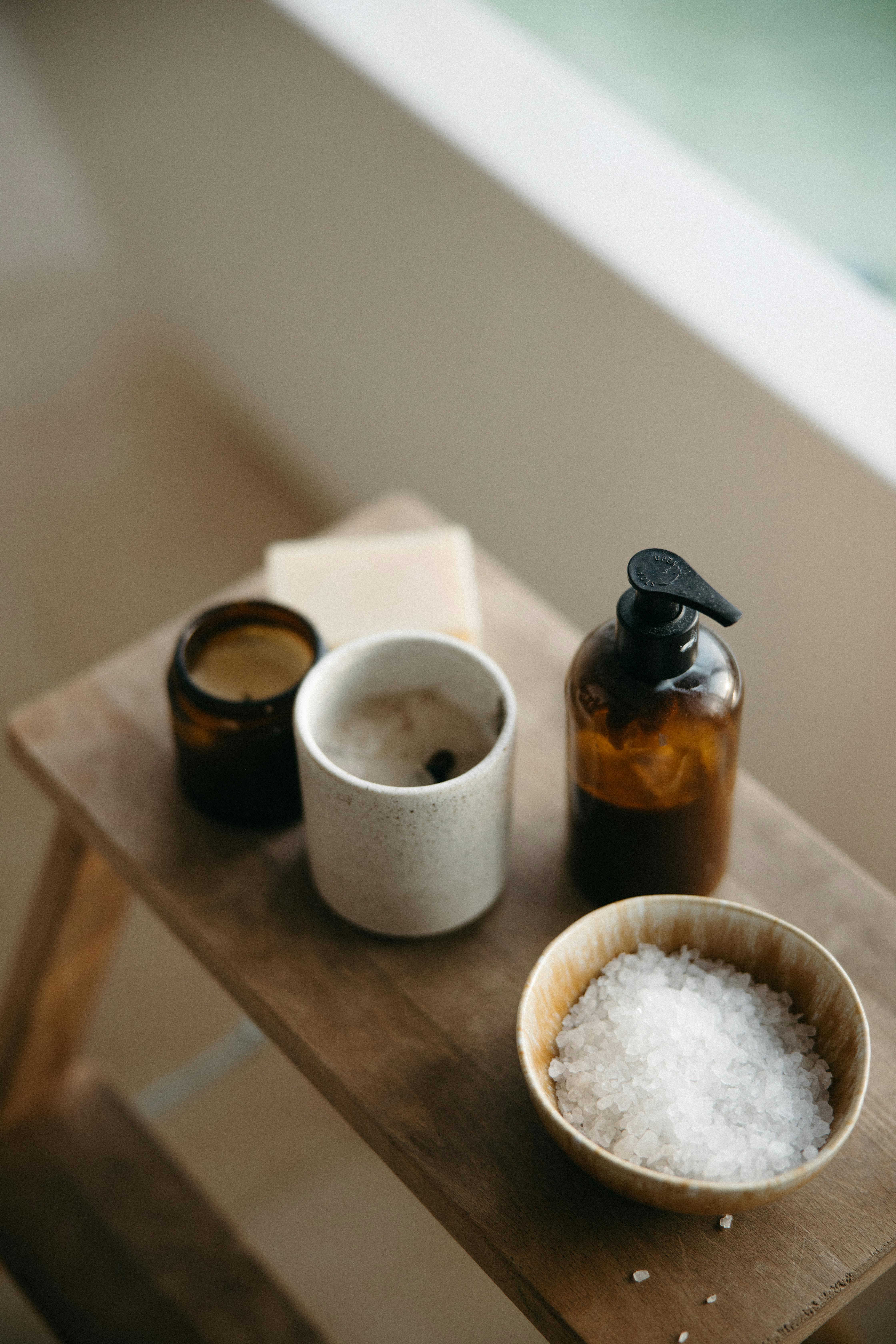 white ceramic mug beside brown ceramic mug on brown wooden table