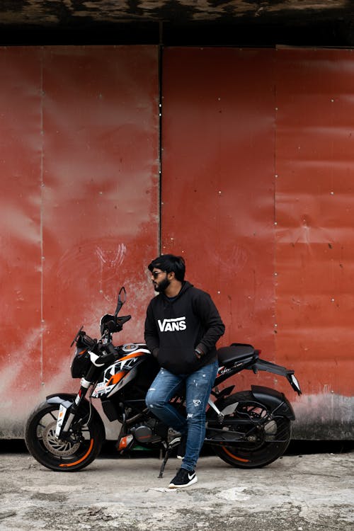 Young Man Leaning on a Motorcycle