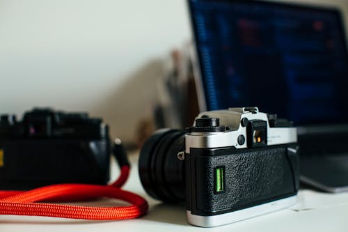 Black and Silver Camera on White Table