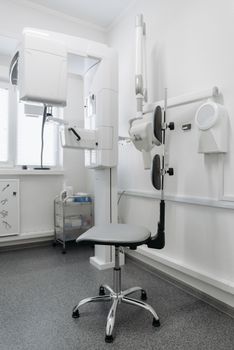 A modern dental clinic showcasing advanced dental equipment and a sleek chair design.