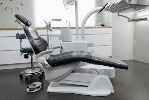 A contemporary dental office with a sleek dental chair and equipment, perfect for healthcare themed needs.