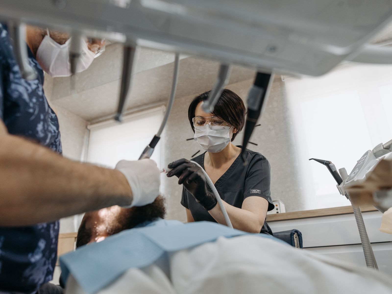 Smiling dental patient and clinician in a bright modern private dental clinic