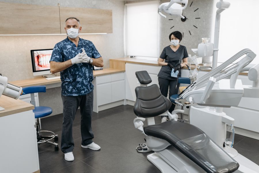 Modern dental clinic with a dentist and assistant treating a patient