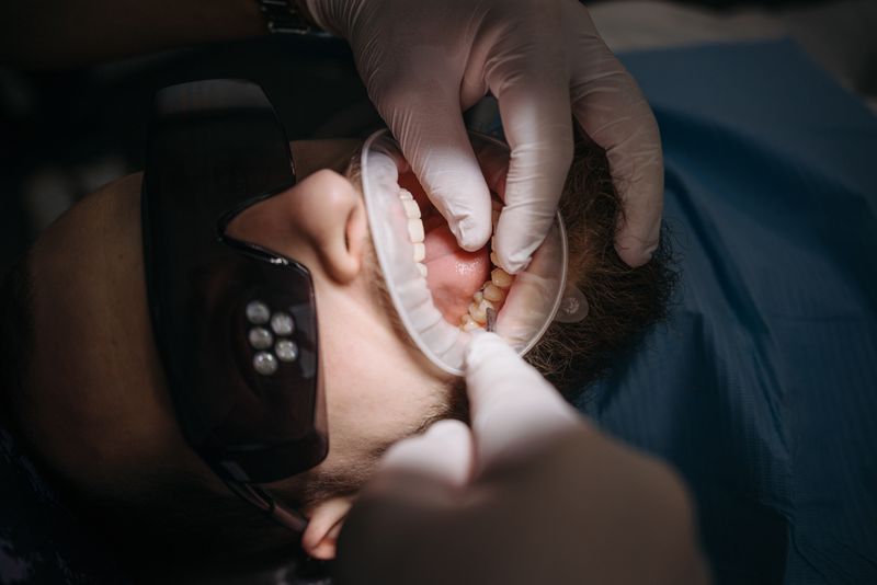 A dentist checking the fit of a clear aligner during a digital treatment appointment