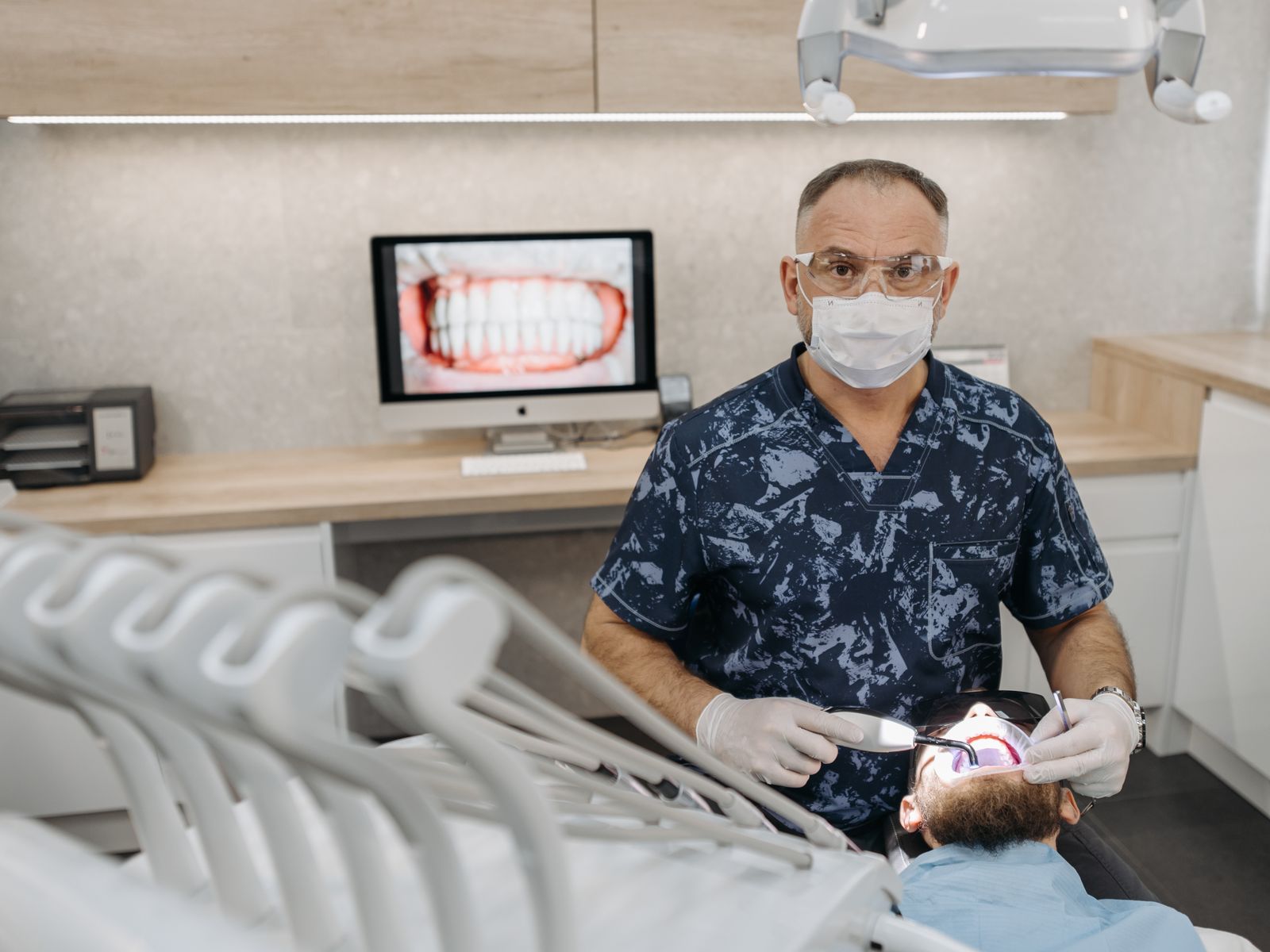 Smiling dental patient and clinician in a bright modern private dental clinic