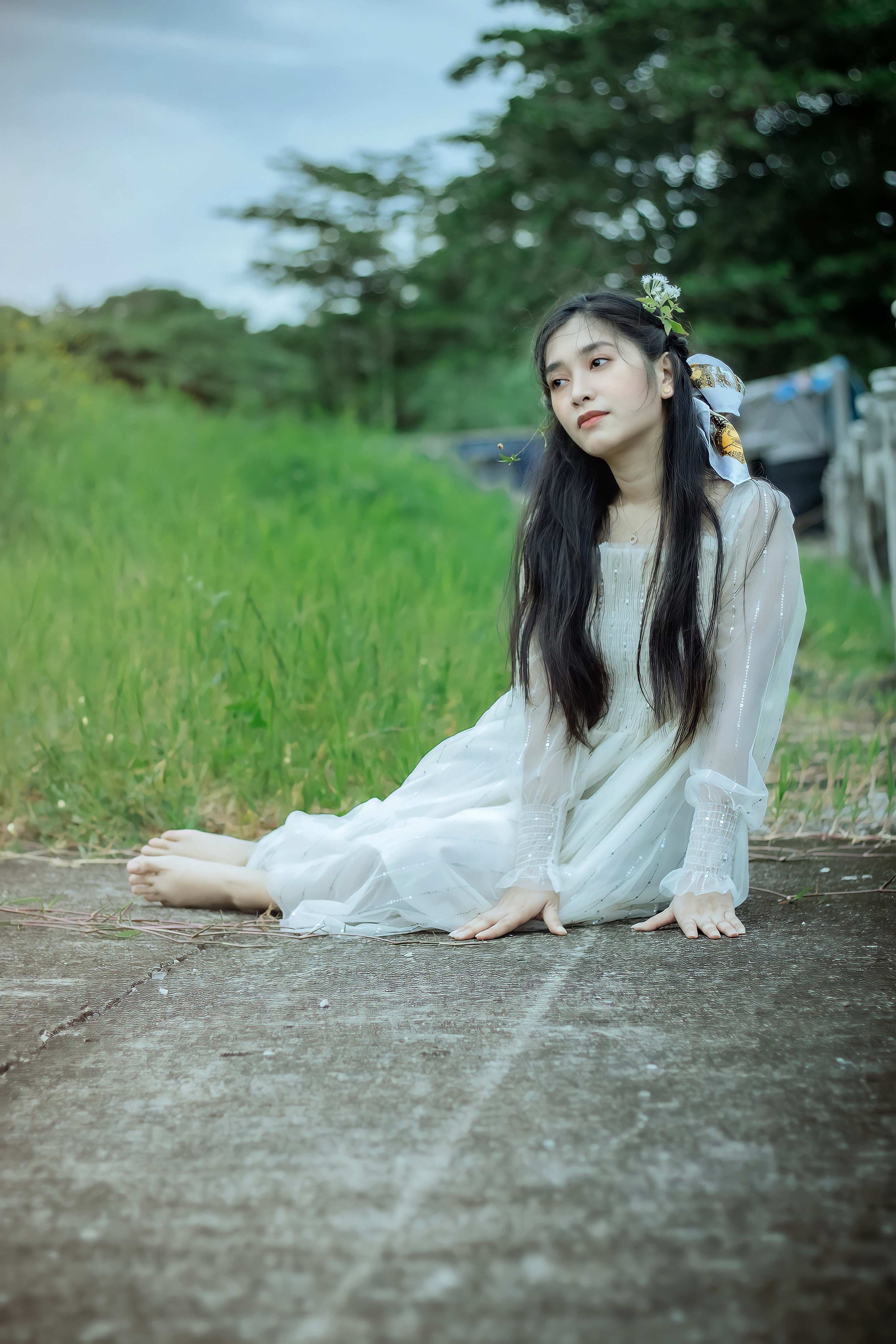 Woman in White Long Sleeve Dress Sitting on Concrete Ground · Free ...